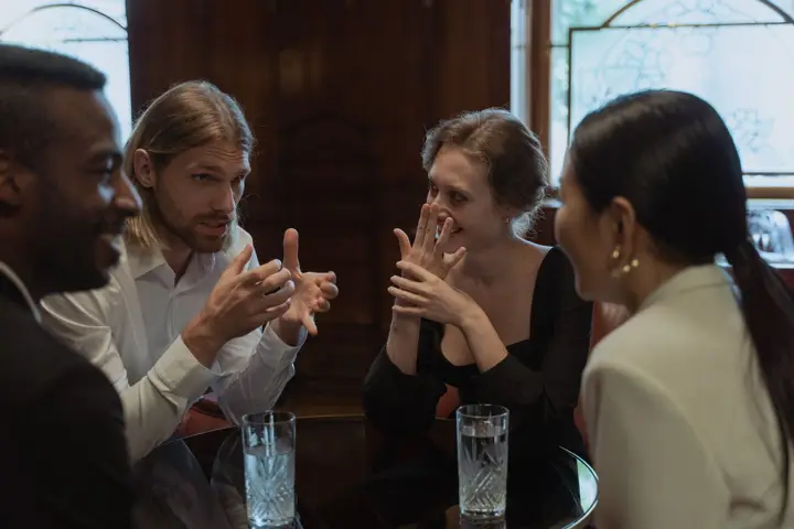 Adults talking around a table